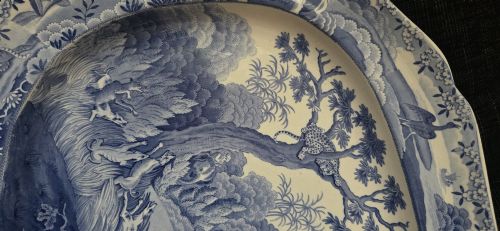 fig 8. An oval blue and white underglaze transfer-printed earthenware meat platter depicting a landscape with hunters on elephants and hounds pursuing a leopard.
