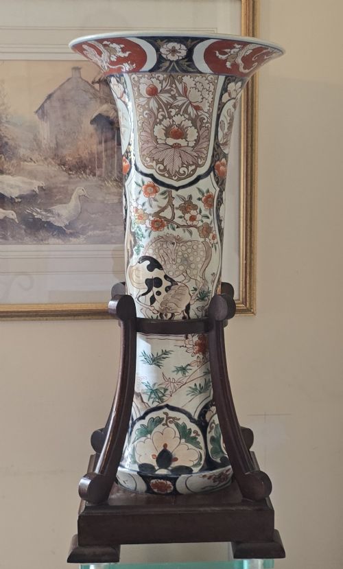 A tall Japanese Imari porcelain trumpet vase featuring hand-painted designs of horses, floral panels, and geometric borders in blue, iron red, and enamels. View XIII