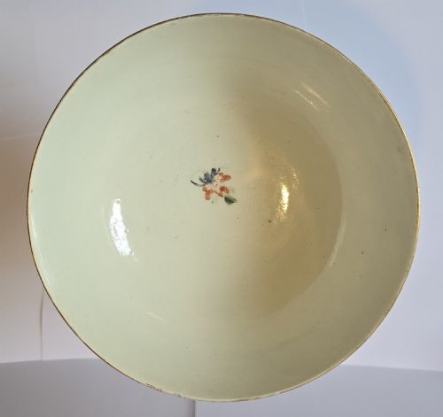 fig 6. An eighteenth-century circular porcelain bowl featuring a blue scale ground, gilded rococo cartouches, and hand-painted Kakiemon floral panels.