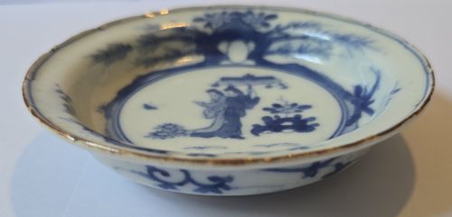fig 5. A circular Edo period Japanese Arita porcelain shallow dish featuring hand-painted cobalt blue underglaze figurative and floral decoration on an off-white ceramic body.