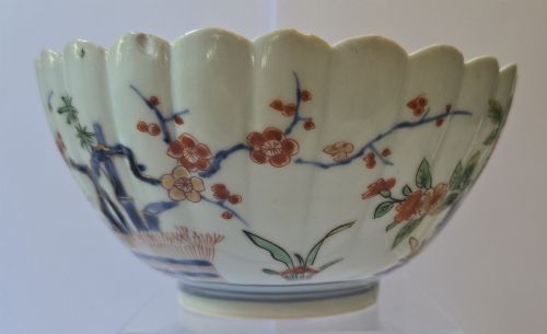 fig 3. A fluted late 17th-century Japanese porcelain bowl decorated with polychrome floral enamel motifs against an off-white background.