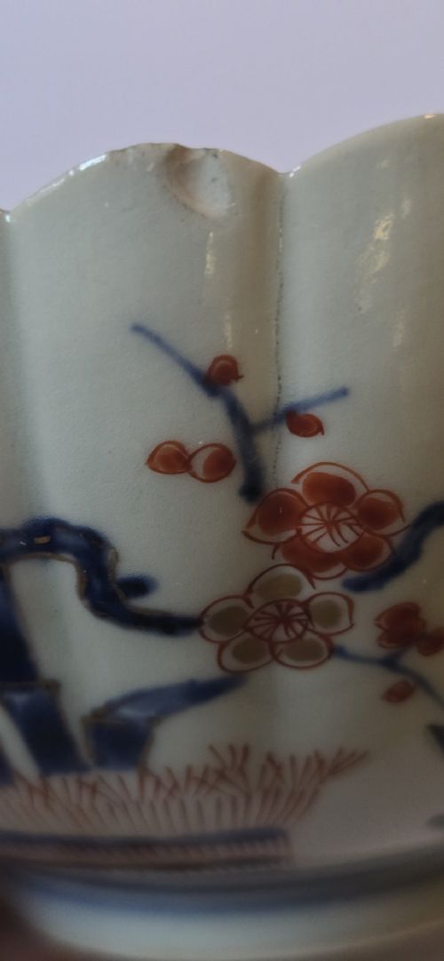 A fluted late 17th-century Japanese porcelain bowl decorated with polychrome floral enamel motifs against an off-white background. View XIV