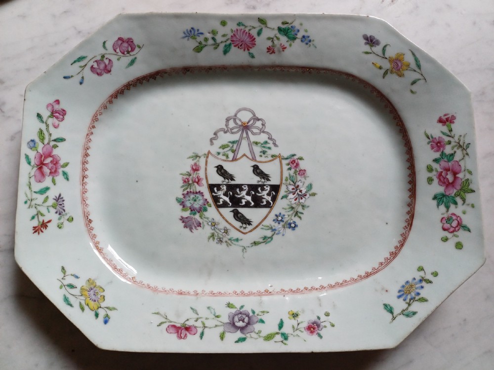 An 18th-century octagonal Chinese porcelain dish decorated with a central heraldic crest and colourful floral enamel sprays along the border. View II