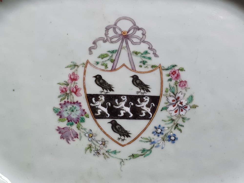 An 18th-century octagonal Chinese porcelain dish decorated with a central heraldic crest and colourful floral enamel sprays along the border. View III