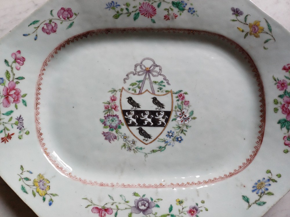 An 18th-century octagonal Chinese porcelain dish decorated with a central heraldic crest and colourful floral enamel sprays along the border. View IV