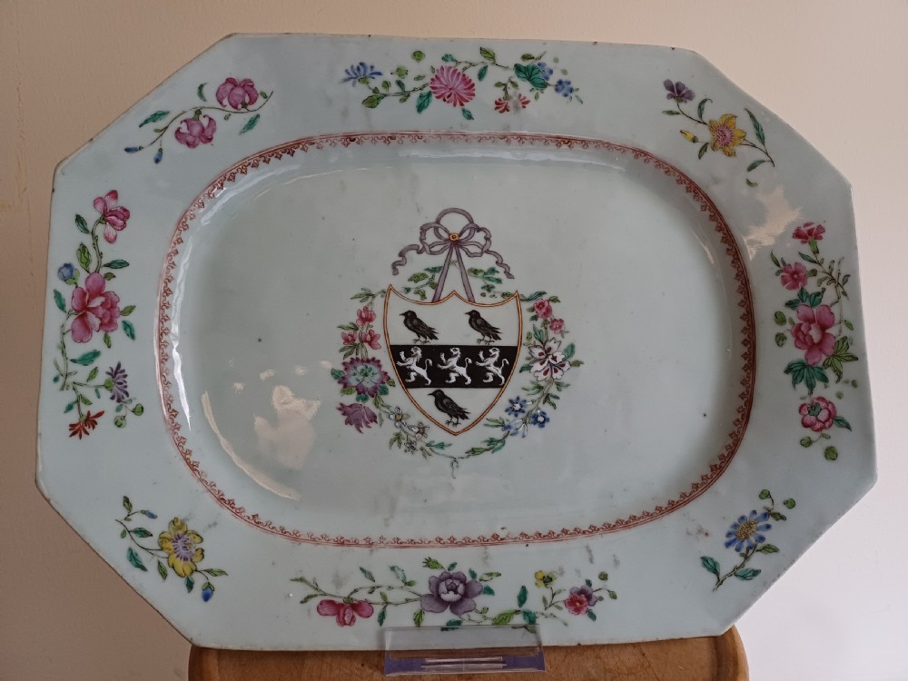An 18th-century octagonal Chinese porcelain dish decorated with a central heraldic crest and colourful floral enamel sprays along the border. View X
