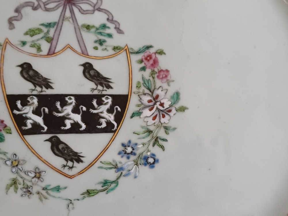 An 18th-century octagonal Chinese porcelain dish decorated with a central heraldic crest and colourful floral enamel sprays along the border. View XI
