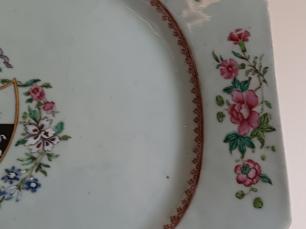 An 18th-century octagonal Chinese porcelain dish decorated with a central heraldic crest and colourful floral enamel sprays along the border. View XII