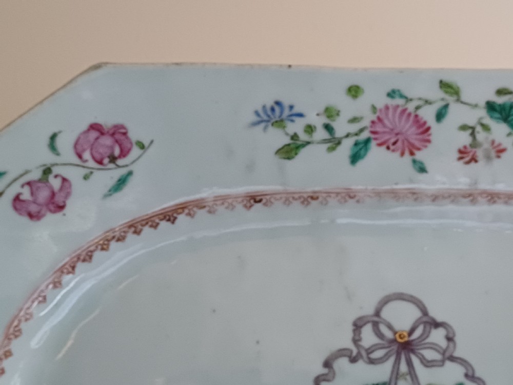 An 18th-century octagonal Chinese porcelain dish decorated with a central heraldic crest and colourful floral enamel sprays along the border. View XIV