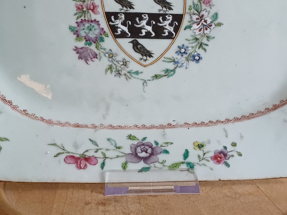 An 18th-century octagonal Chinese porcelain dish decorated with a central heraldic crest and colourful floral enamel sprays along the border. View XVI