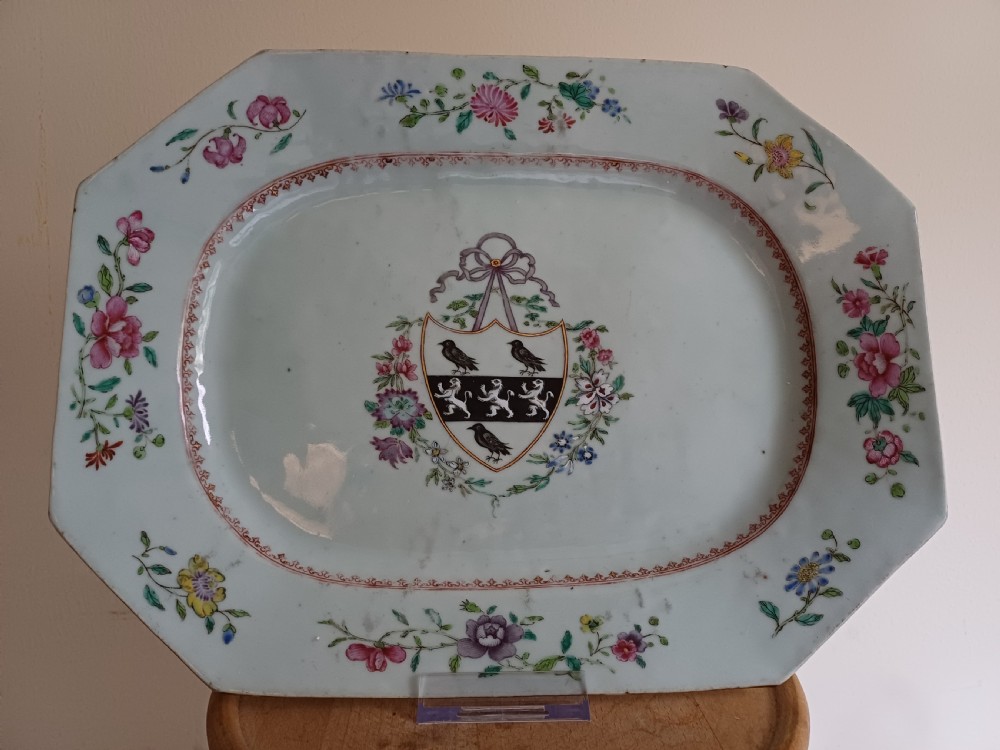 An 18th-century octagonal Chinese porcelain dish decorated with a central heraldic crest and colourful floral enamel sprays along the border. View XVII