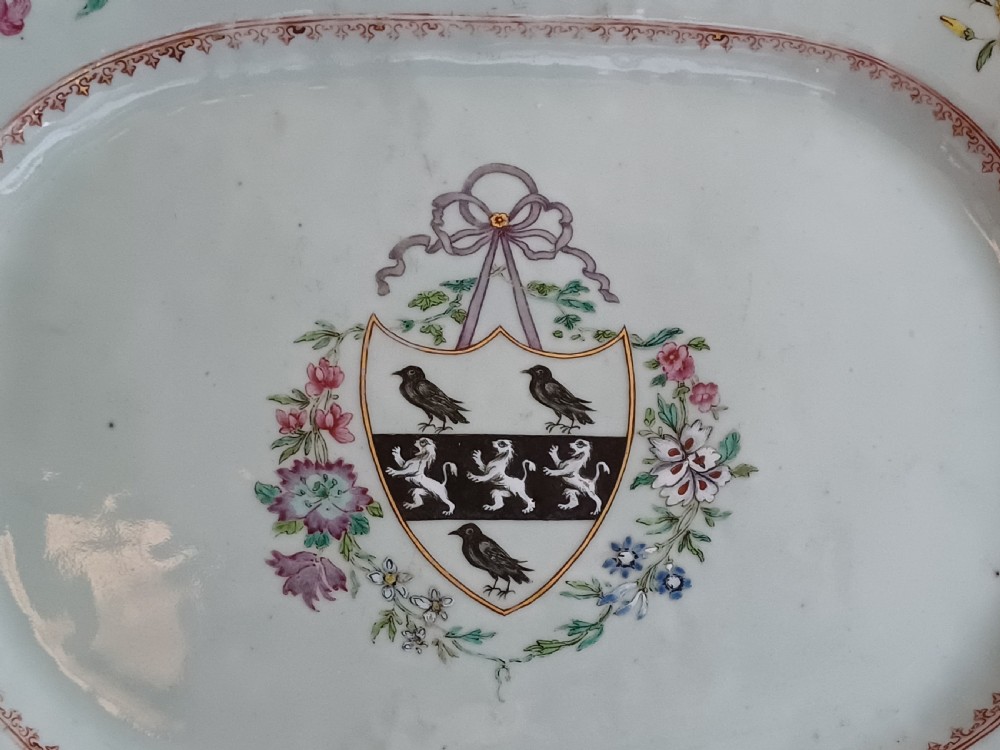 An 18th-century octagonal Chinese porcelain dish decorated with a central heraldic crest and colourful floral enamel sprays along the border. View XVIII