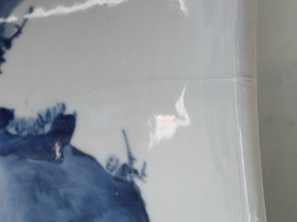 A tall Japanese Arita blue and white porcelain beaker vase featuring a flared trumpet rim and painted Kano style landscape motifs. View IX