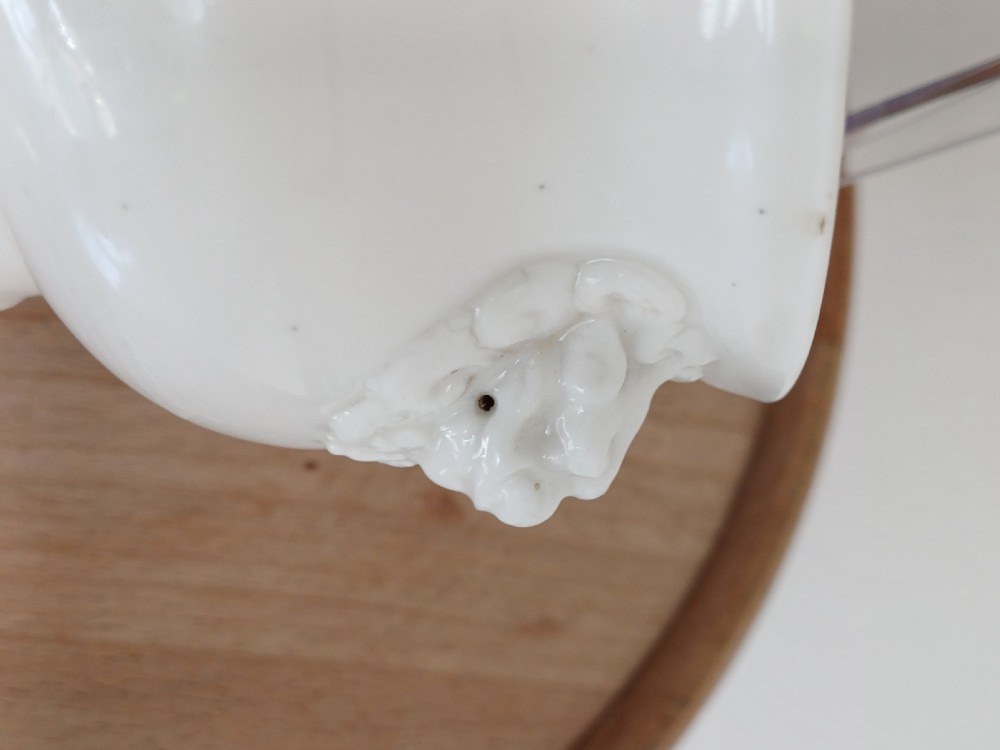 A small round ivory white glazed porcelain censer featuring moulded mask handles on either side and a short flared foot base. View VII