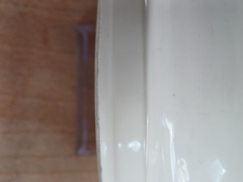 A small round ivory white glazed porcelain censer featuring moulded mask handles on either side and a short flared foot base. View VIII