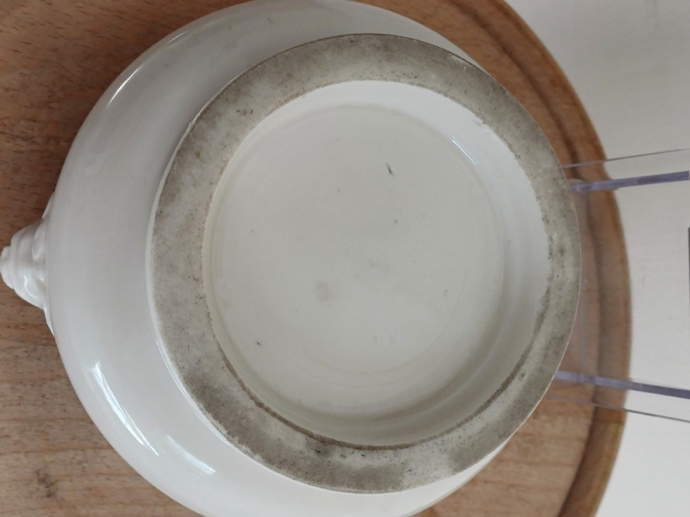 A small round ivory white glazed porcelain censer featuring moulded mask handles on either side and a short flared foot base. View XIII