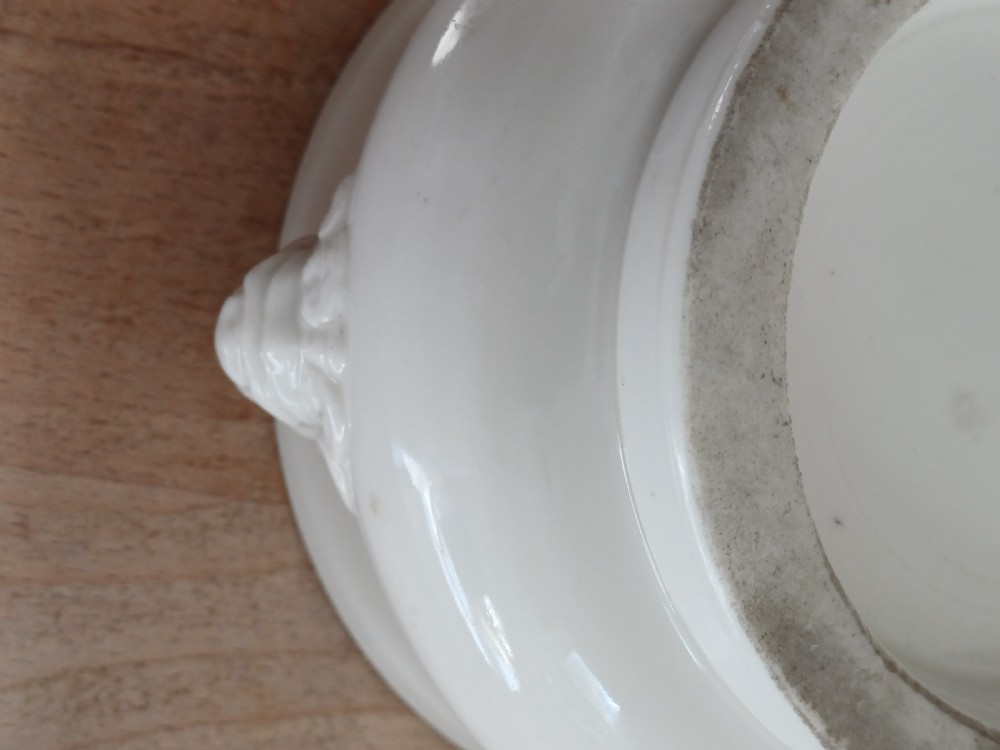 A small round ivory white glazed porcelain censer featuring moulded mask handles on either side and a short flared foot base. View XVII