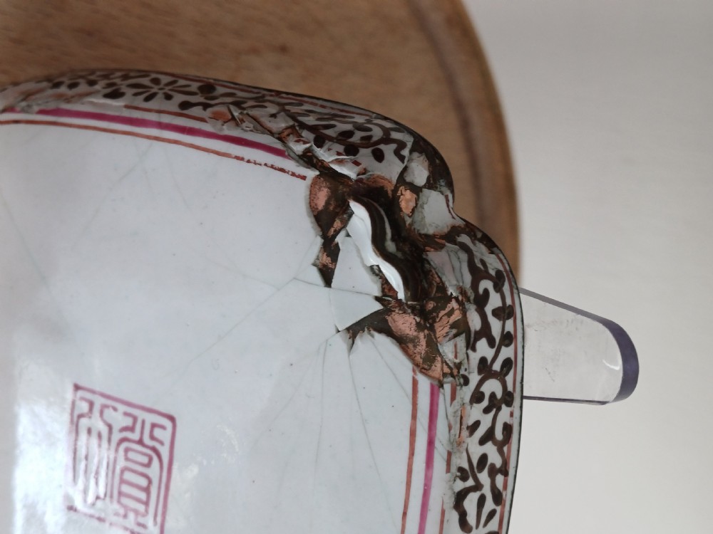 A square 18th-century Chinese Canton enamel dish with lobed corners, depicting figures in a landscape in famille rose enamels framed by a patterned border. View VIII