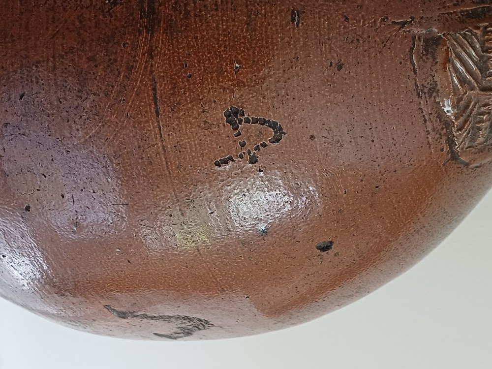 A large bulbous brown salt-glazed stoneware flagon with a narrow neck and single curved loop handle. View IV