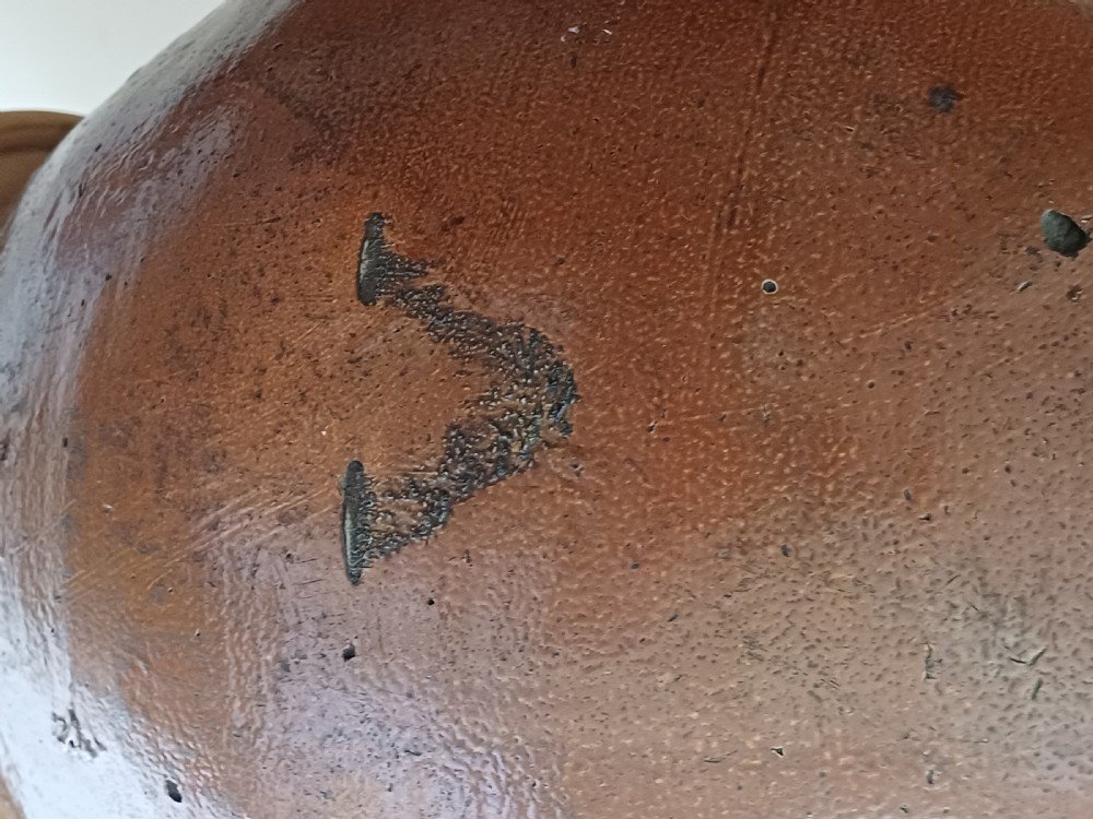 A large bulbous brown salt-glazed stoneware flagon with a narrow neck and single curved loop handle. View V