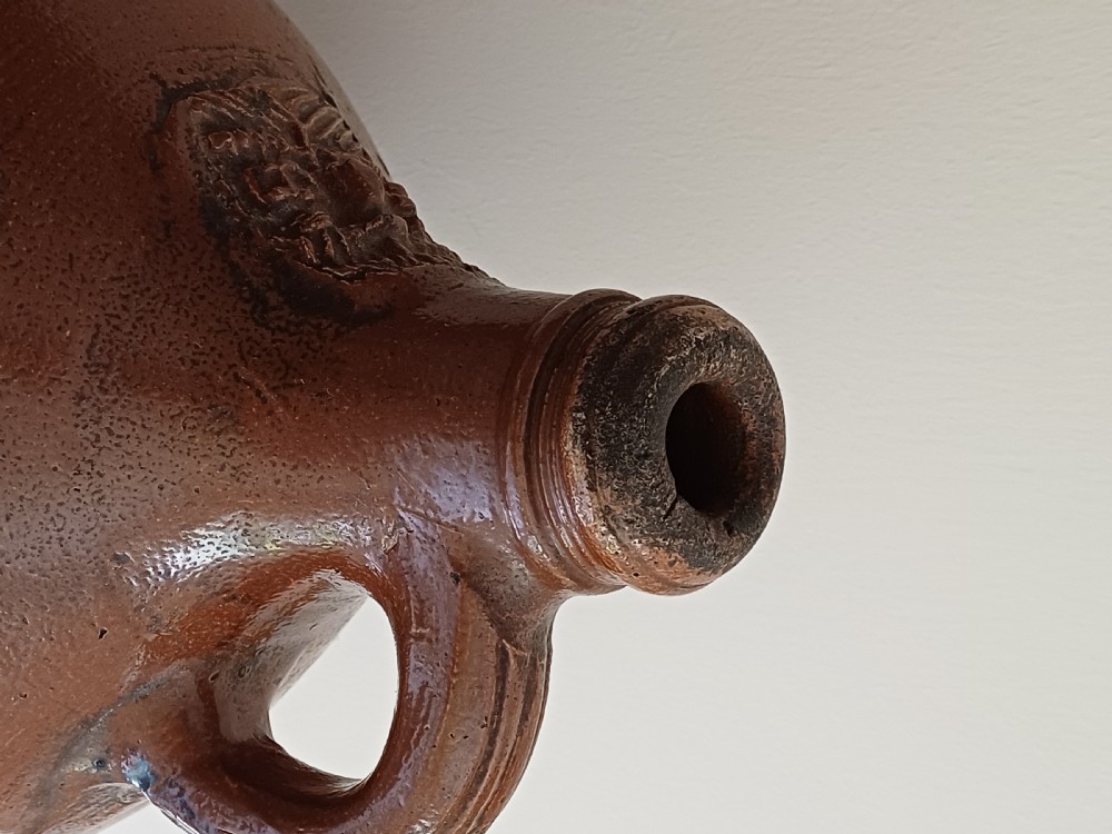 A large bulbous brown salt-glazed stoneware flagon with a narrow neck and single curved loop handle. View VII
