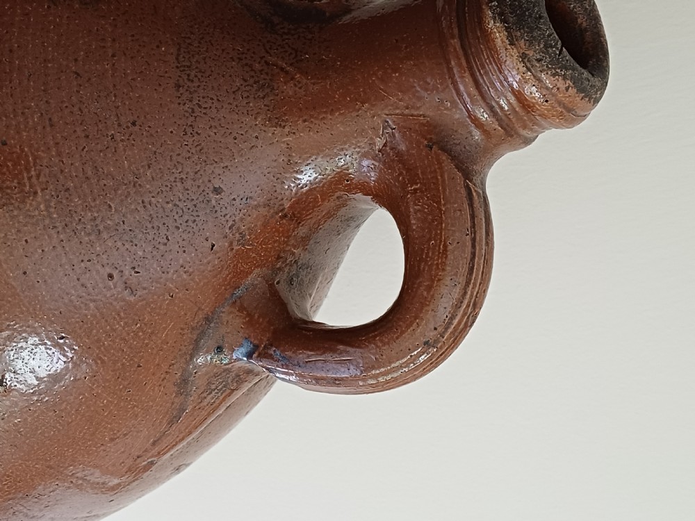 A large bulbous brown salt-glazed stoneware flagon with a narrow neck and single curved loop handle. View VIII