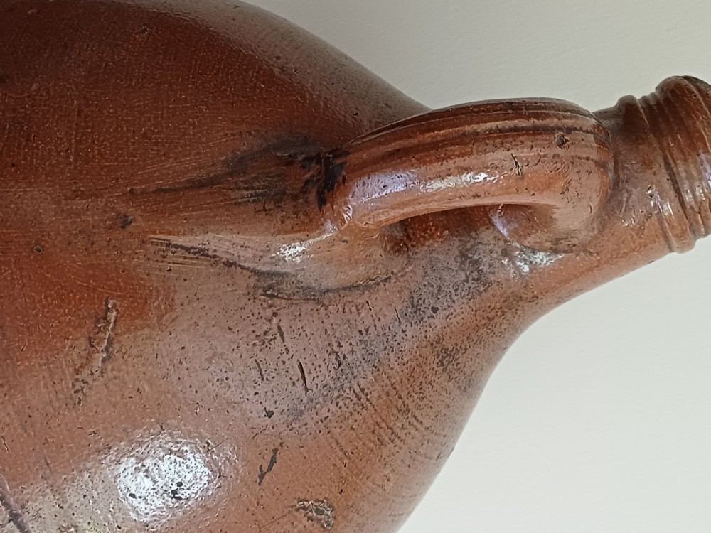 A large bulbous brown salt-glazed stoneware flagon with a narrow neck and single curved loop handle. View XI
