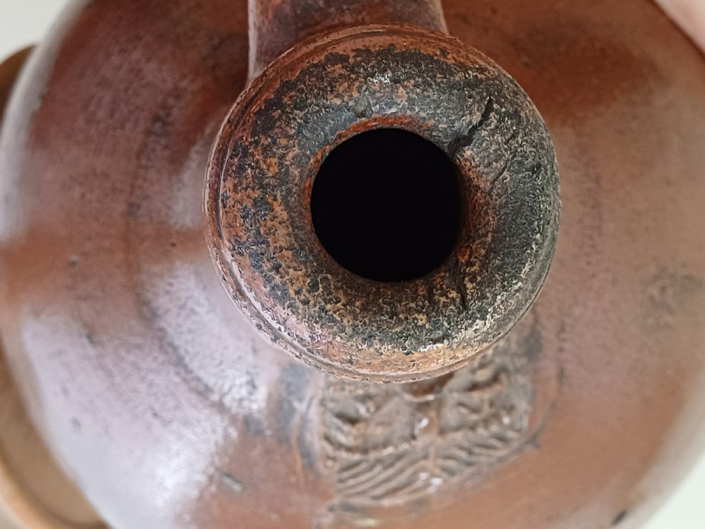 A large bulbous brown salt-glazed stoneware flagon with a narrow neck and single curved loop handle. View XIII
