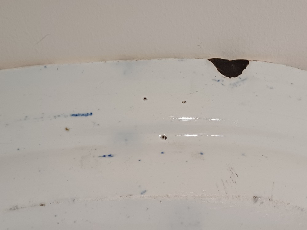 A large Victorian oval earthenware platter decorated with a cobalt blue and white transfer print featuring a pastoral river scene and a wide floral border. View XI