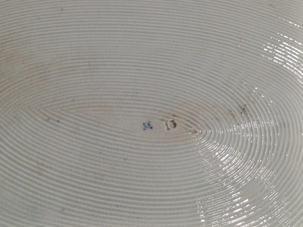 A large oval blue and white earthenware meat platter featuring a transfer-printed Chinese garden scene with figures, bridges, and floral borders. View VIII