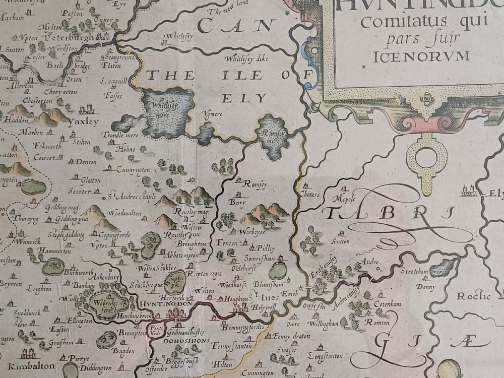 A framed 17th-century hand-coloured map of Huntingdon by Christopher Saxton set within an off-white mount and slim gilded frame. View III