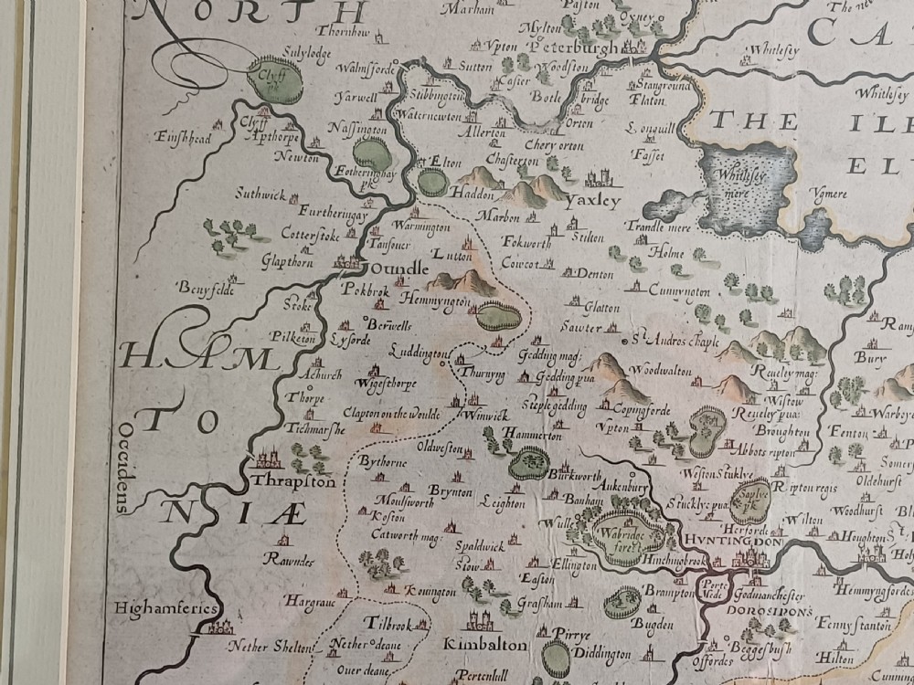 A framed 17th-century hand-coloured map of Huntingdon by Christopher Saxton set within an off-white mount and slim gilded frame. View VIII
