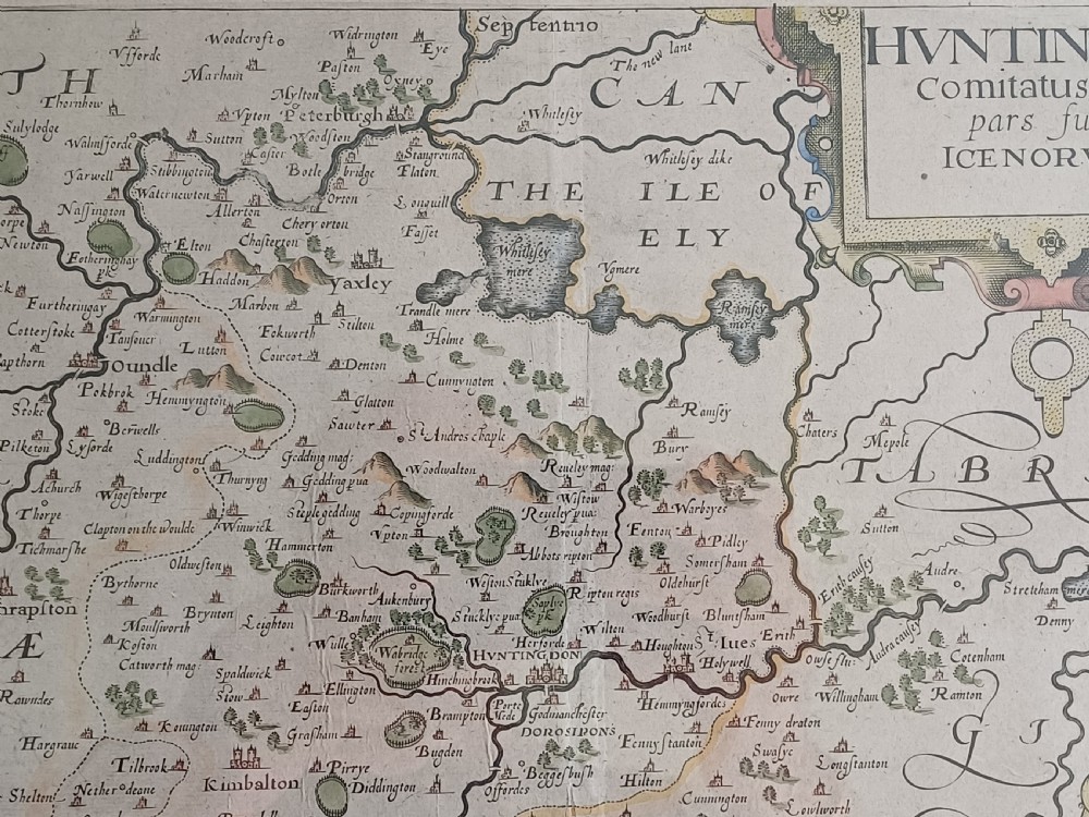 A framed 17th-century hand-coloured map of Huntingdon by Christopher Saxton set within an off-white mount and slim gilded frame. View XI