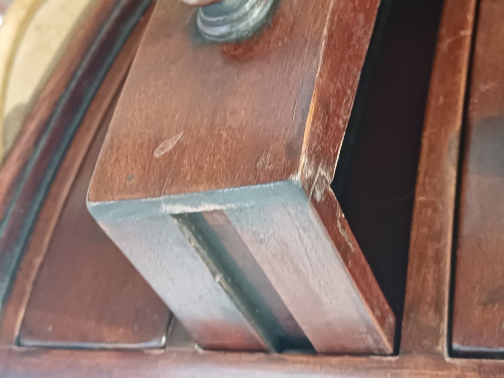 A Victorian miniature bow-fronted mahogany chest featuring three graduated drawers with turned wood knobs and bun feet. View VIII