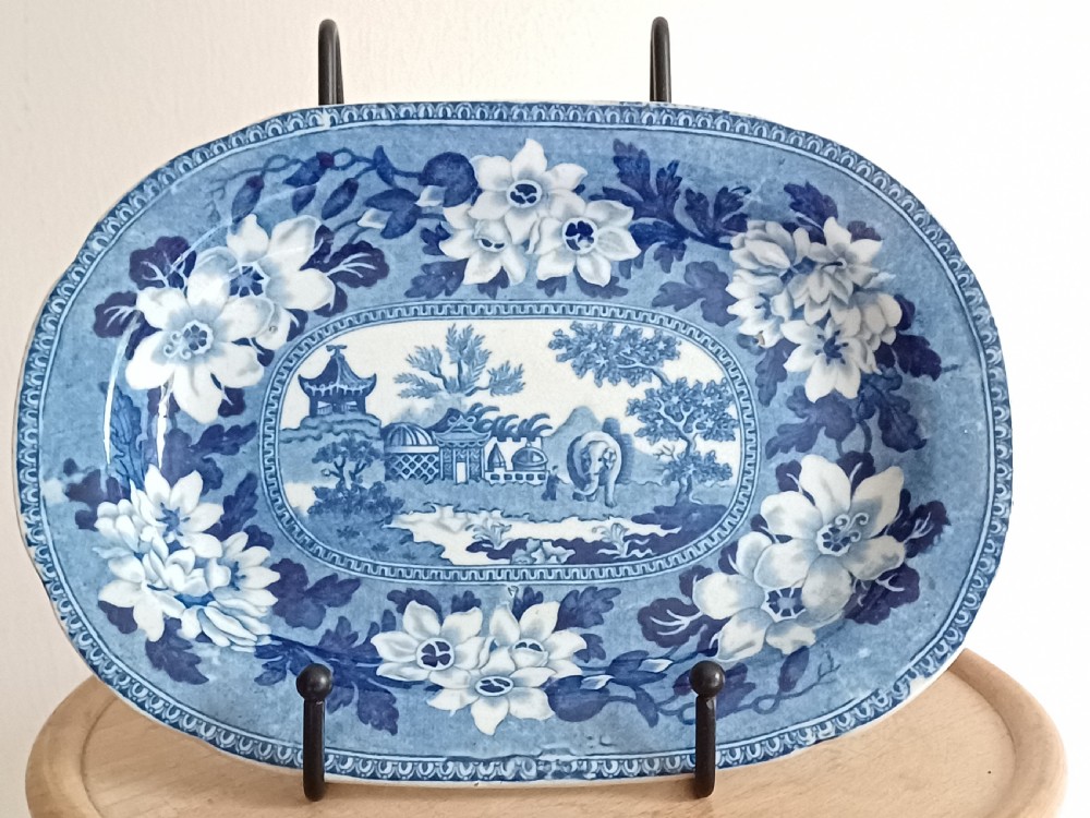 A Georgian blue and white transfer-printed ceramic sauce tureen featuring floral patterns, lion head side handles, a lion finial lid, and a matching underplate. View VIII