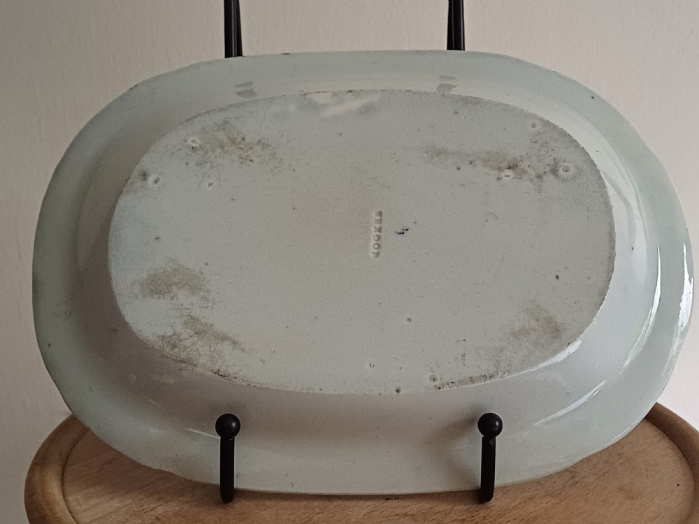 A Georgian blue and white transfer-printed ceramic sauce tureen featuring floral patterns, lion head side handles, a lion finial lid, and a matching underplate. View XI