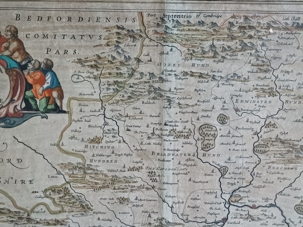 A framed 17th-century hand-coloured map of Hertfordshire by cartographer Jan Blaeu featuring decorative heraldic coats of arms and a title cartouche. View III
