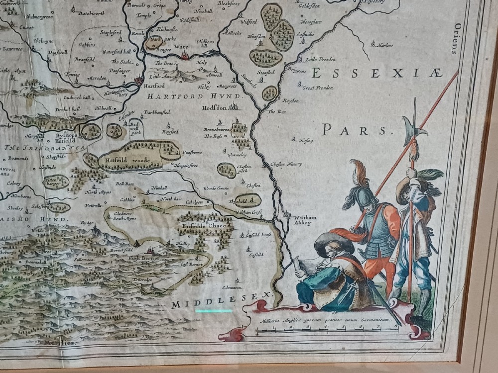 A framed 17th-century hand-coloured map of Hertfordshire by cartographer Jan Blaeu featuring decorative heraldic coats of arms and a title cartouche. View VIII