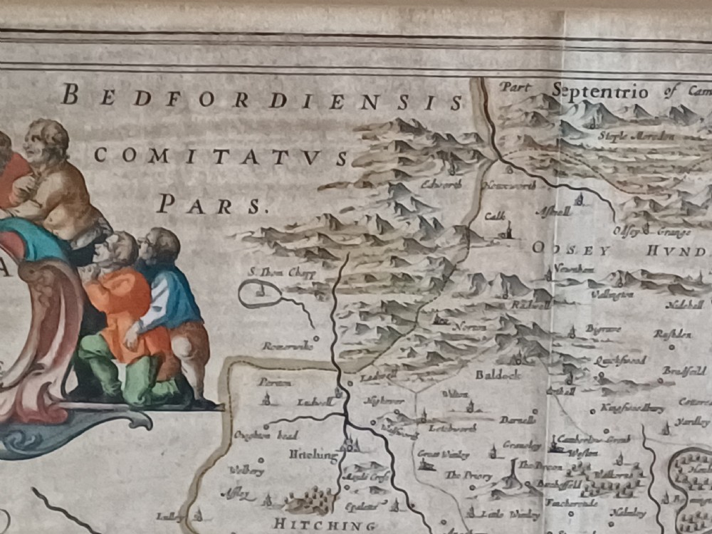 A framed 17th-century hand-coloured map of Hertfordshire by cartographer Jan Blaeu featuring decorative heraldic coats of arms and a title cartouche. View XI