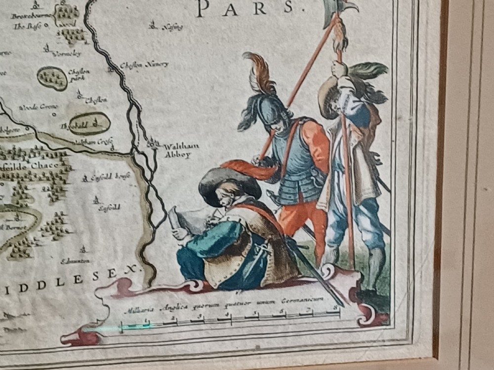 A framed 17th-century hand-coloured map of Hertfordshire by cartographer Jan Blaeu featuring decorative heraldic coats of arms and a title cartouche. View XVIII