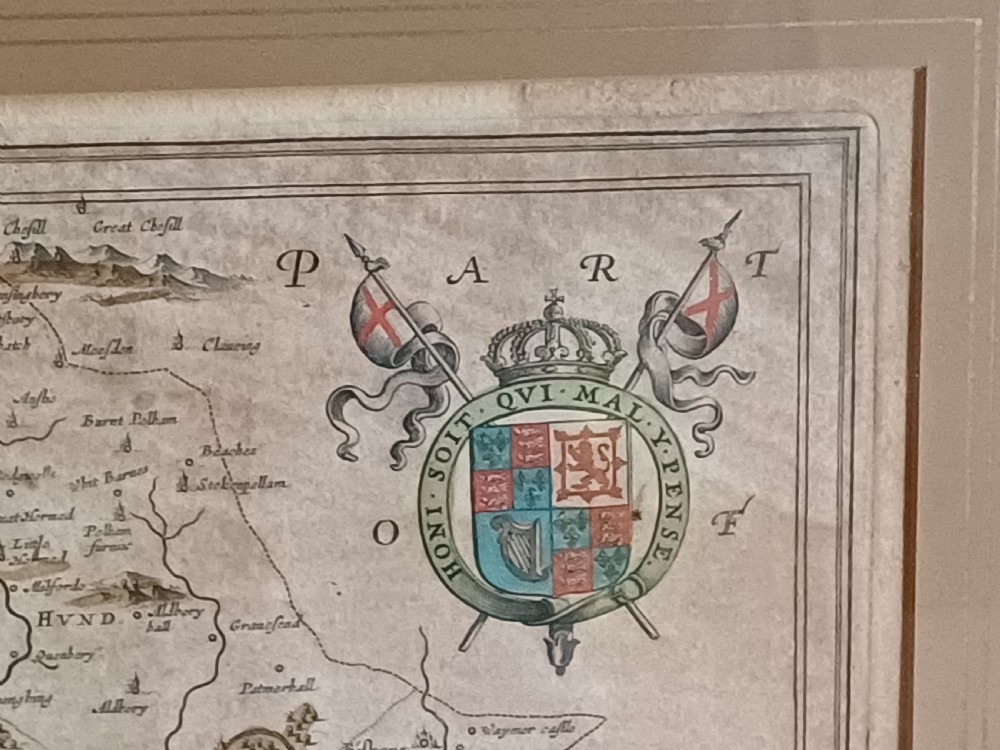 A framed 17th-century hand-coloured map of Hertfordshire by cartographer Jan Blaeu featuring decorative heraldic coats of arms and a title cartouche. View XIX