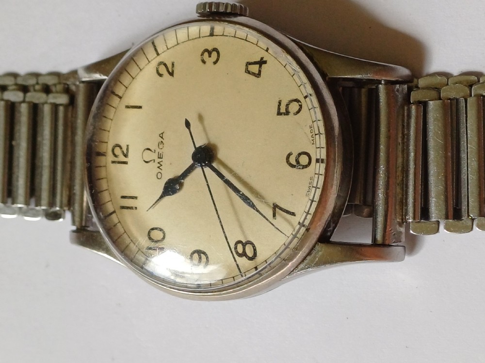 Vintage Omega 6B159 military pilot wristwatch with a cream dial, Arabic numerals, and a stainless steel case. View III