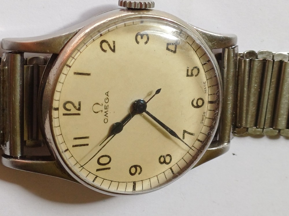 Vintage Omega 6B159 military pilot wristwatch with a cream dial, Arabic numerals, and a stainless steel case. View IV