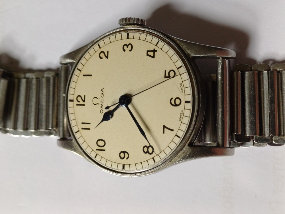 Vintage Omega 6B159 military pilot wristwatch with a cream dial, Arabic numerals, and a stainless steel case. View XIII