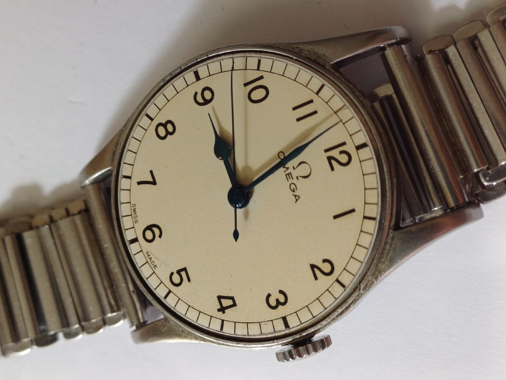 Vintage Omega 6B159 military pilot wristwatch with a cream dial, Arabic numerals, and a stainless steel case. View XIV