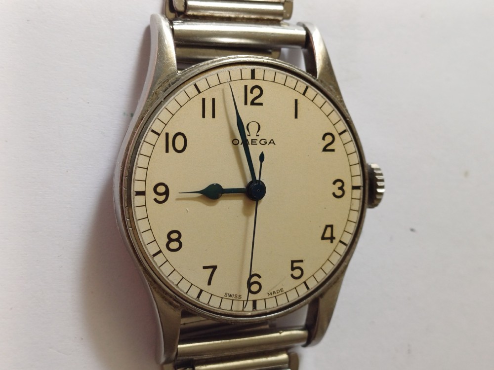 Vintage Omega 6B159 military pilot wristwatch with a cream dial, Arabic numerals, and a stainless steel case. View XV