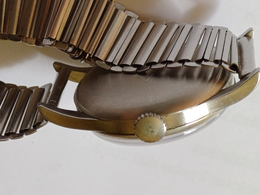 Vintage Omega 6B159 military pilot wristwatch with a cream dial, Arabic numerals, and a stainless steel case. View XX