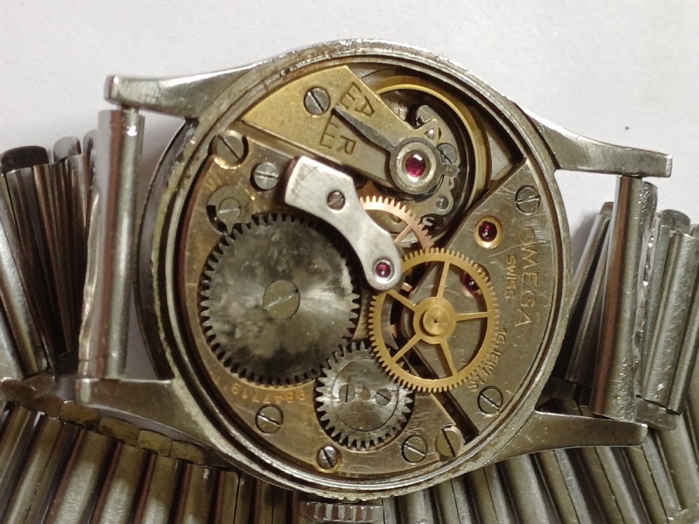 Vintage Omega 6B159 military pilot wristwatch with a cream dial, Arabic numerals, and a stainless steel case. View XXX