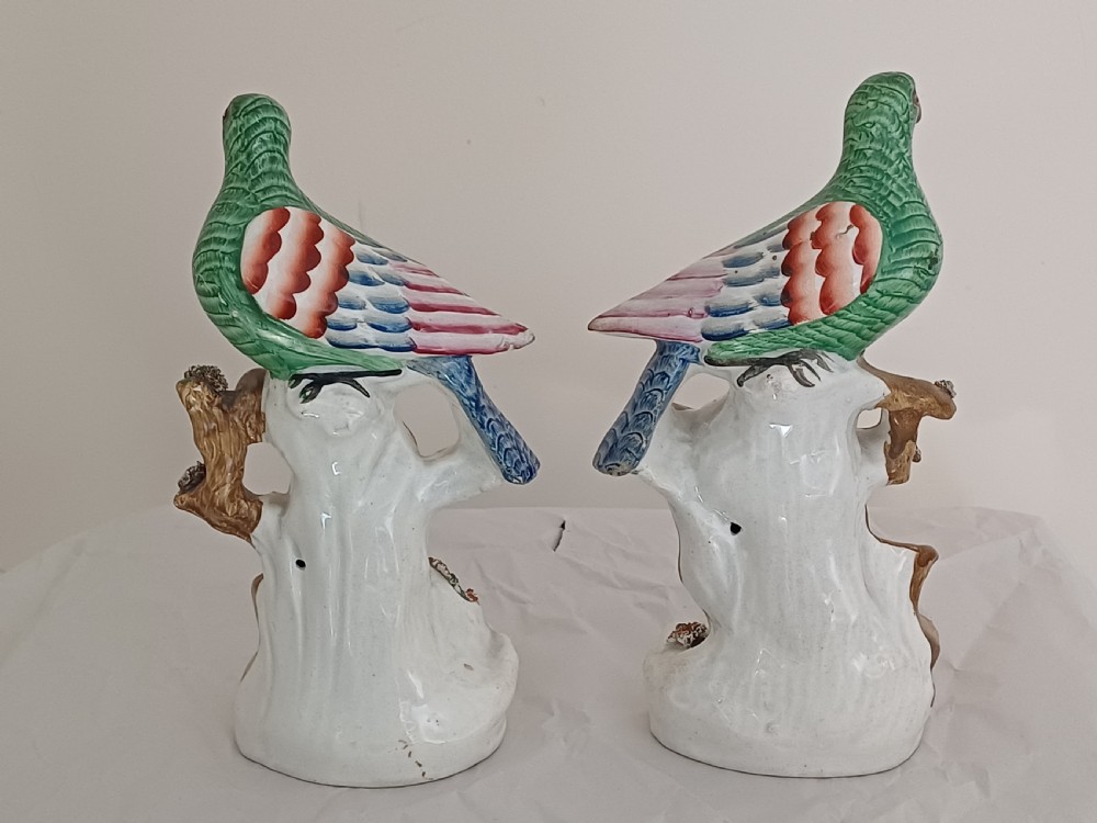 Reserved AD A rare pair of Staffordshire figures of a bird, possibly a pigeon or dove, seated on a tree with a nest of eggs below. Each one is brightly painted and dating circa 1860 View II