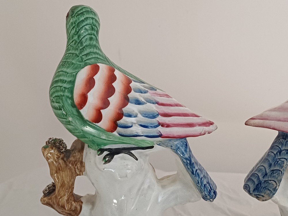 Reserved AD A rare pair of Staffordshire figures of a bird, possibly a pigeon or dove, seated on a tree with a nest of eggs below. Each one is brightly painted and dating circa 1860 View V